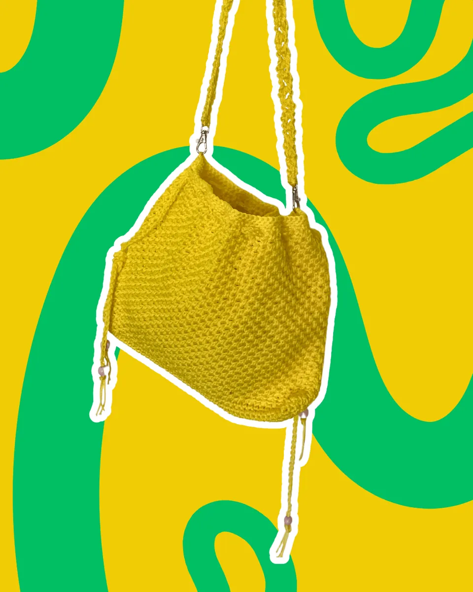 Borsa Secchiello Crochet "Sunshine Yellow" — Un'esplosione di energia per i tuoi outfit! Realizzata a mano all'uncinetto con una ricca trama in rilievo, questa borsa a sacchetto in vivacissimo giallo limone è l'accessorio estivo per eccellenza. Pratica, versatile e super leggera, è dotata di chiusura regolabile con cordino rifinito da perline e comoda tracolla in tinta. Il pezzo ideale per portare sempre un raggio di sole con te!